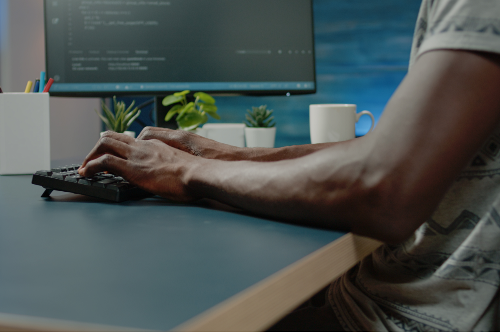 Man typing on computer keyboard